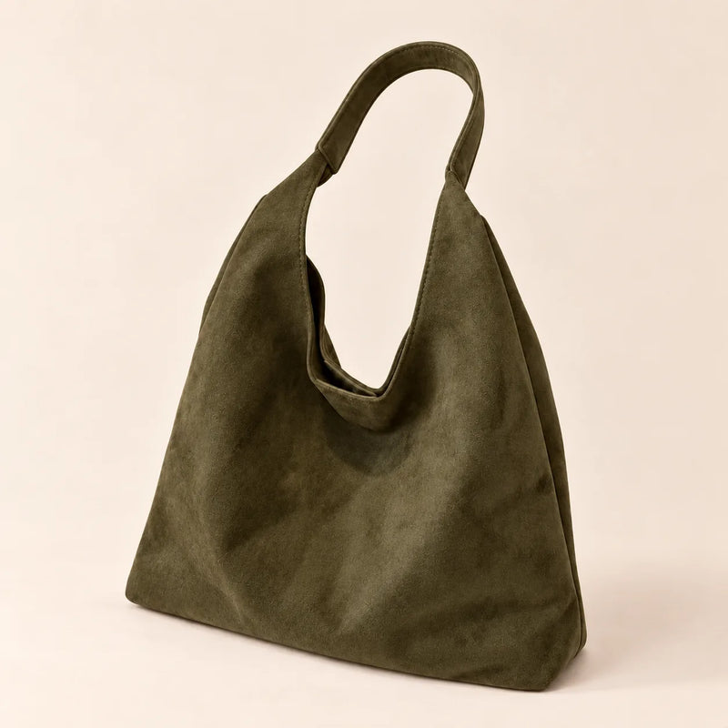 Olive Green faux suede shoulder bag with a single fixed strap on a sand background