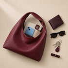 Featherlight Woven Hobo bag shown with phone, wallet and keys fitting inside
