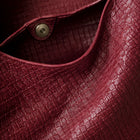 Close-up of the hand-woven vegan leather texture on the Featherlight Woven Hobo