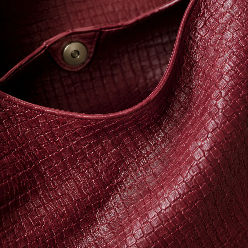 Close-up of the hand-woven vegan leather texture on the Featherlight Woven Hobo